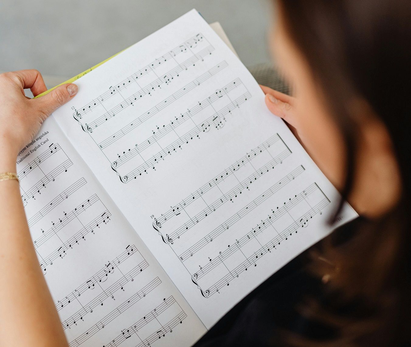 female teacher looking over musical score