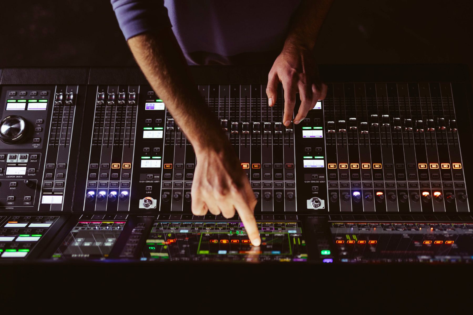 man pointing at audio mixer