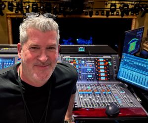 man next to audio mixer