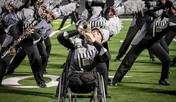 Micah Diffee performing in his wheelchair with marching band