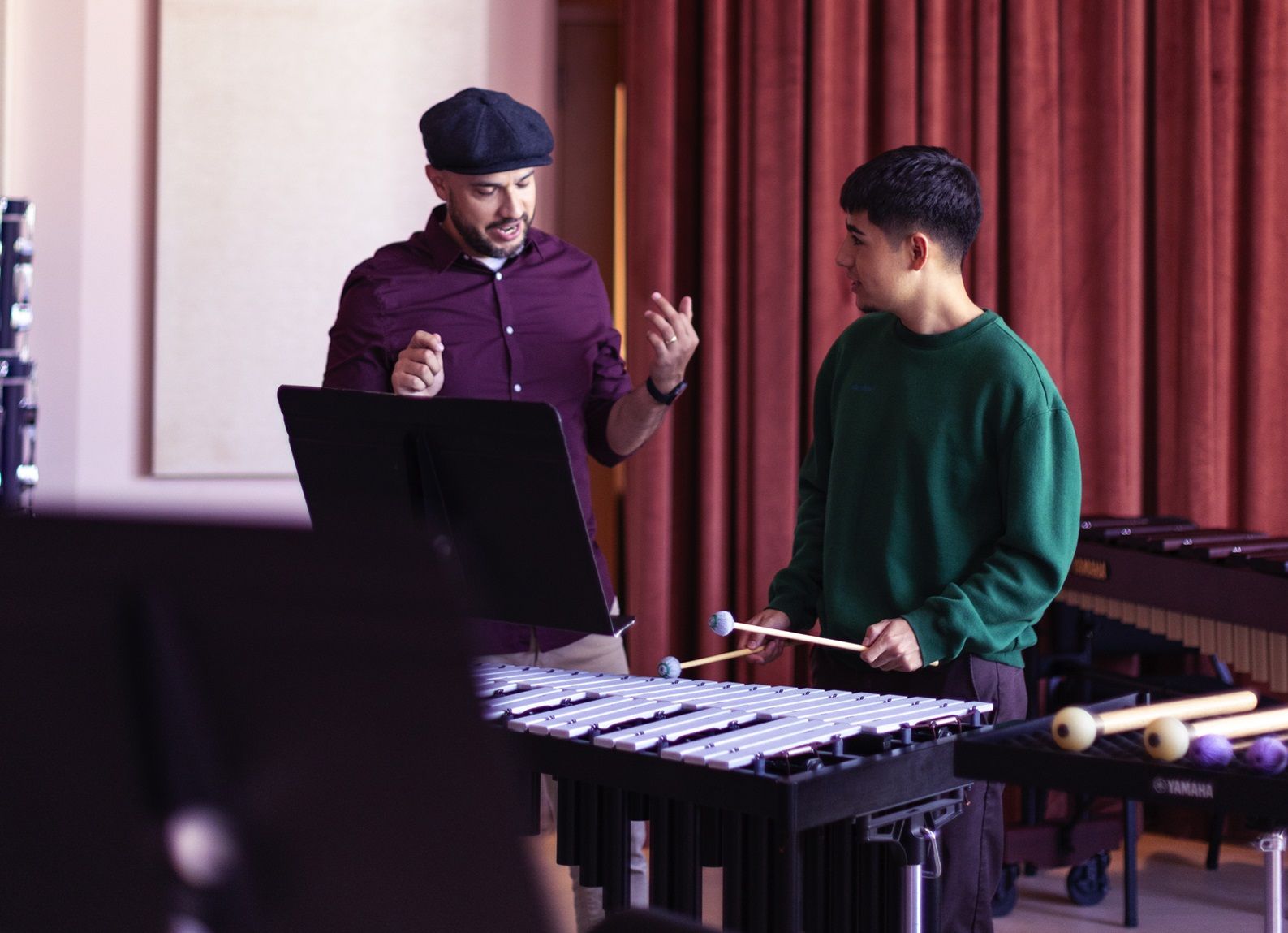 music educator talking to percussion student