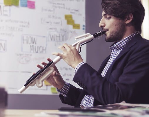 Teacher playing a wind instrument in a classroom.