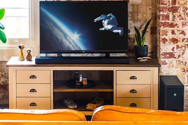 Living room with surround sound system visible.