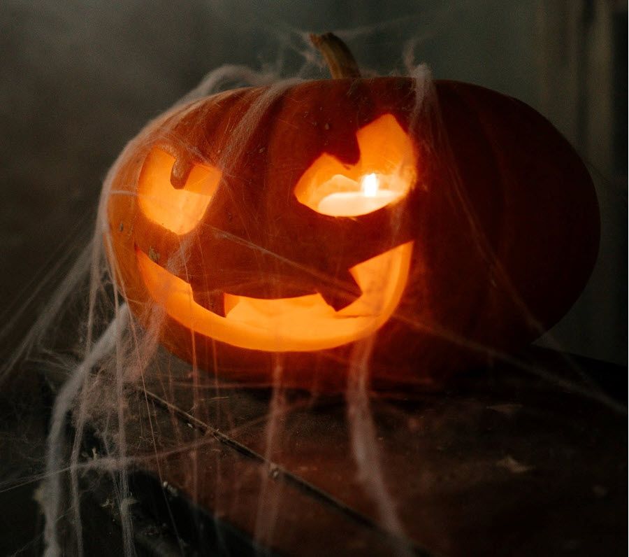 Jack-o-lantern with scary face lit from within.