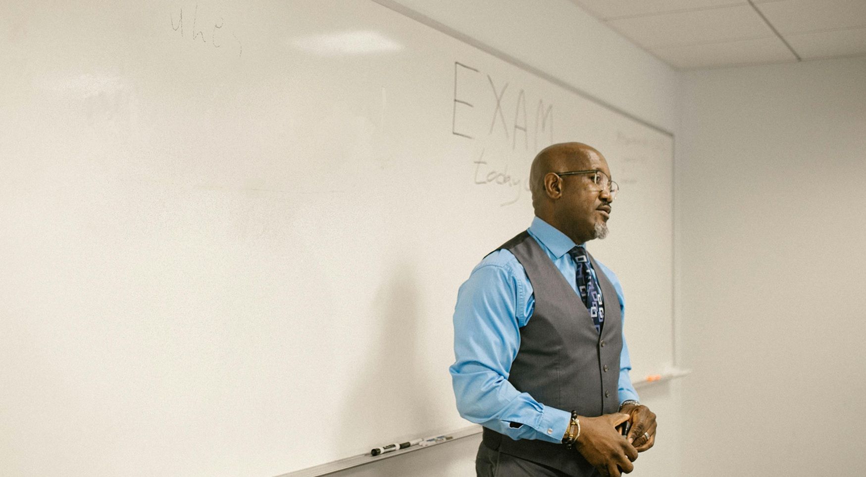 male Black teacher in front of class