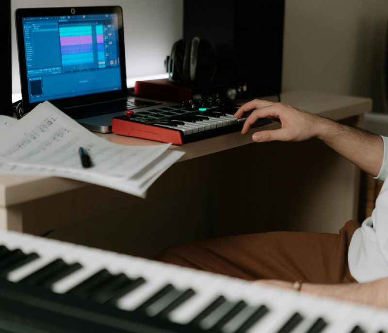 three students working at DAWs