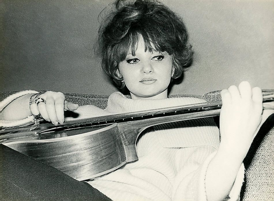 Young woman playing an acoustic guitar.