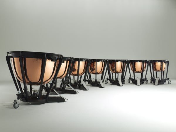 Curved row of timpani with 7 timpani drums.