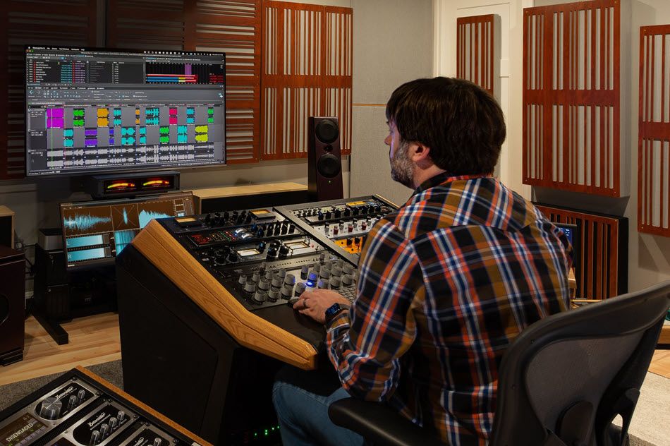 Man working at a soundboard.