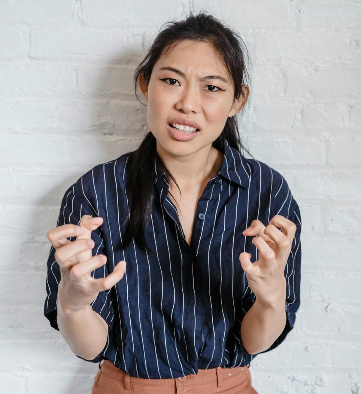 frustrated teacher with clenched hands held in front of her