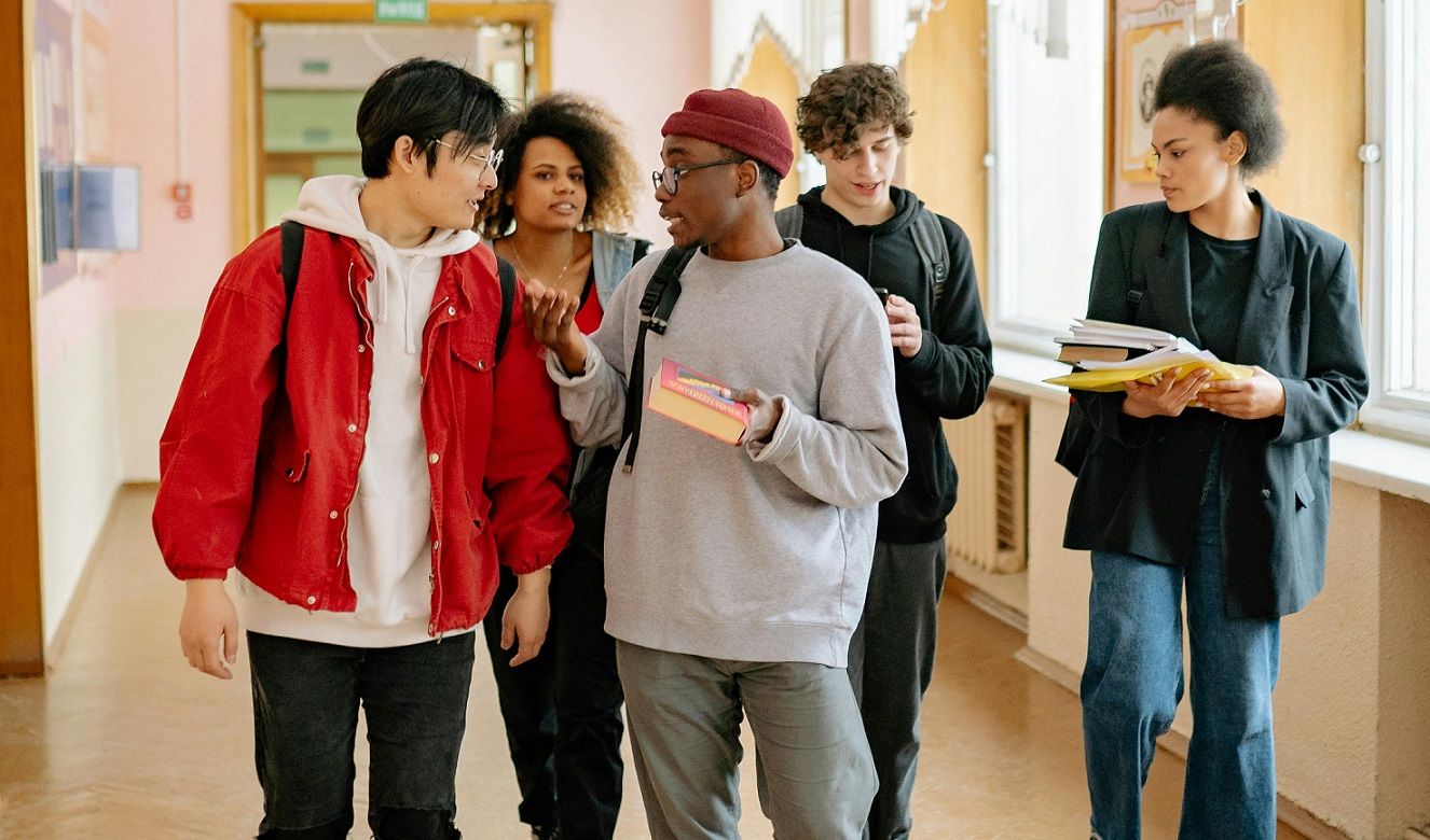 group of students walking in the hallway at school