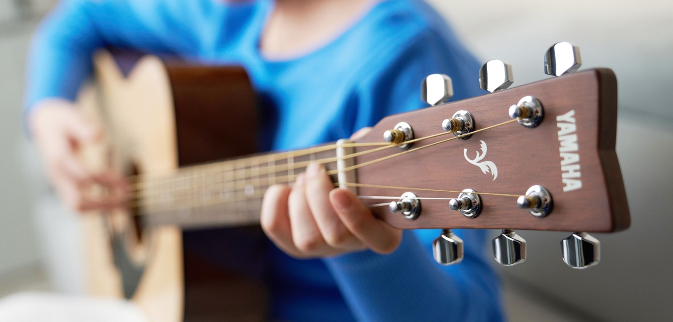 closeup of someone playing an acoustic guitar
