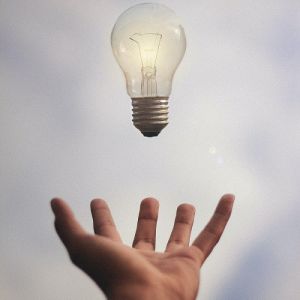 light bulb floating above open hand