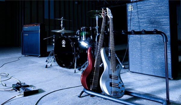 Electric basses in rack onstage with amps.