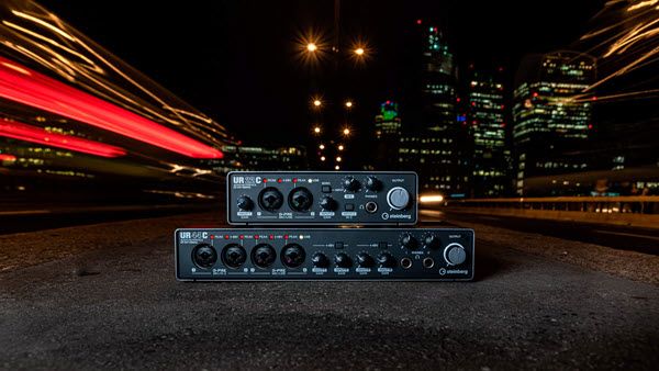 Audio equipment against a graphic backdrop depicting a night cityscape.