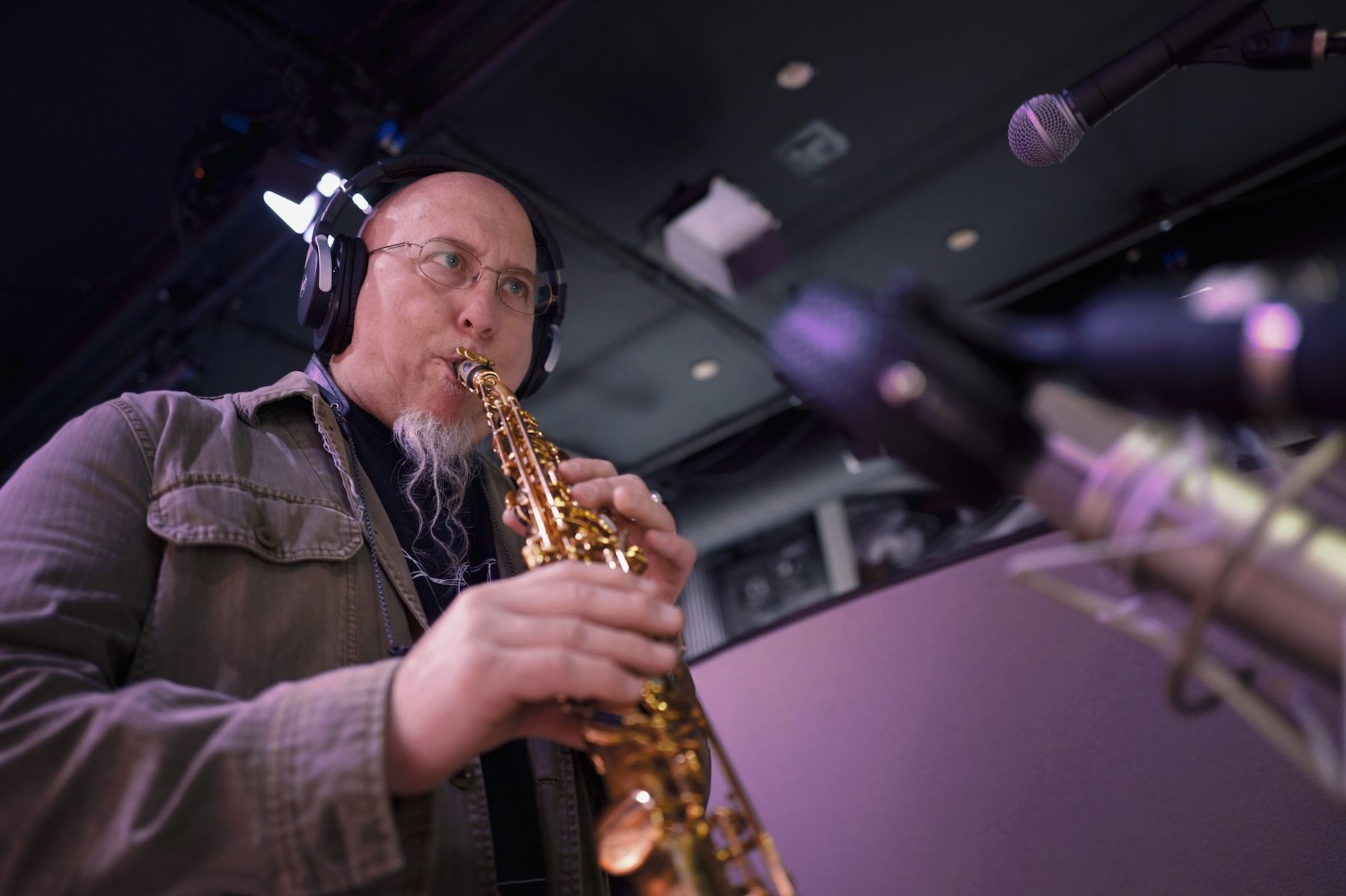 man playing soprano saxophone in a studio