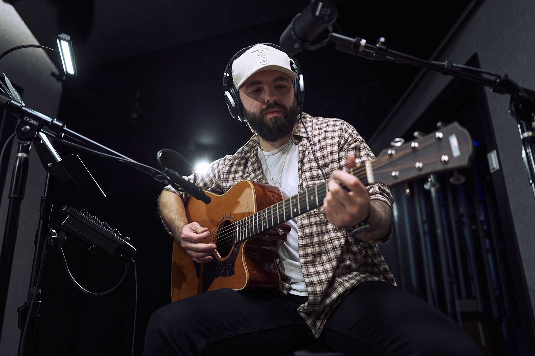 Color portrait, Tanner Olsen playing guitar in the studio