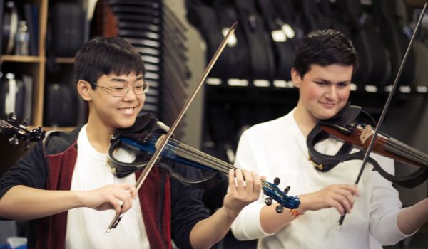 orchestra rehearsal with two students playing silent violins