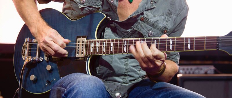 Man playing electric guitar.