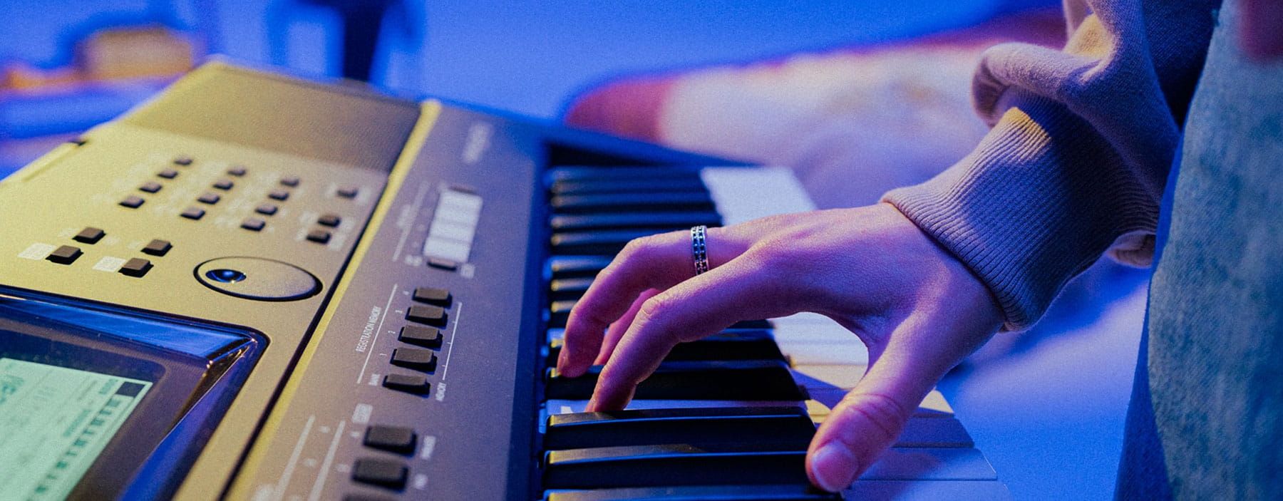 Hands playing on an electric keyboard