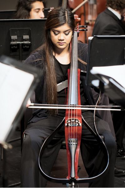 Young female cellist playing.