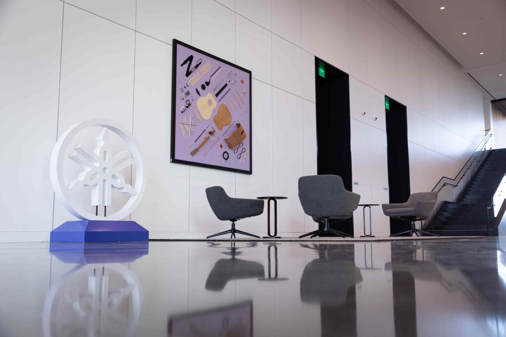 An office building lobby with a unique art piece on the wall.