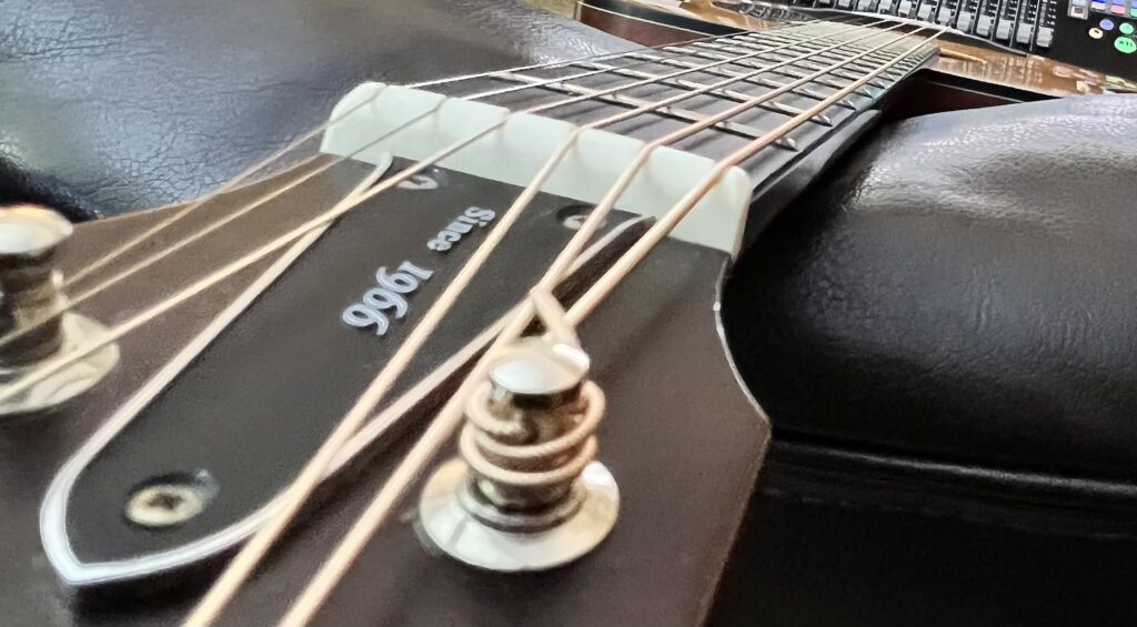 A guitar neck, seen from the headstock down on the bass side.