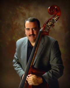 A man posing with a bass.