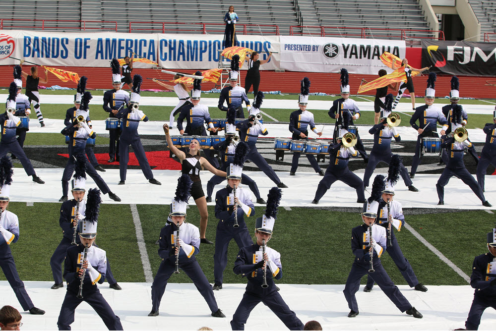 A marching band dancing at an event.
