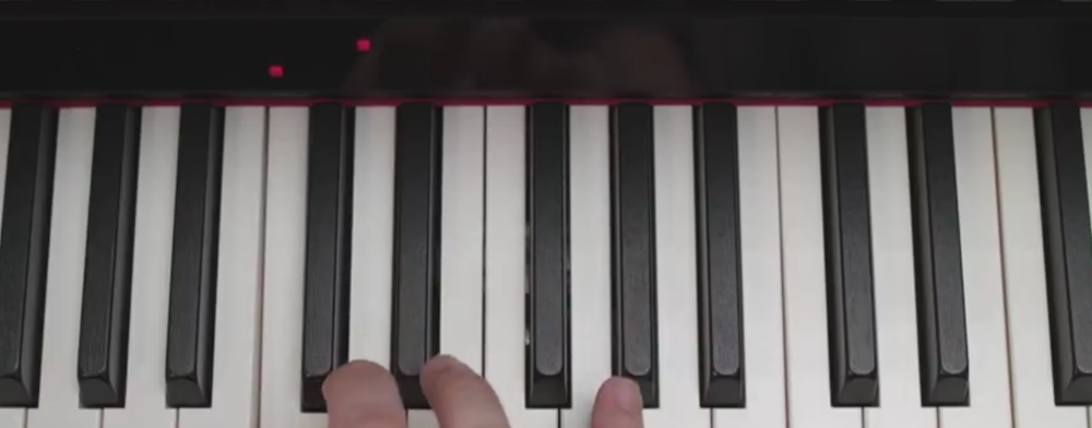 Photo showing light on above key on keyboard showing current note to play and the next one pianist should play.