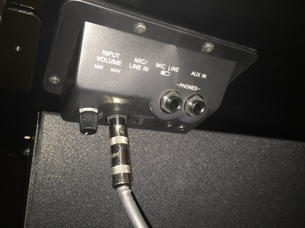 Shows microphone cable plugged into "mic/line in" for Clavinova.