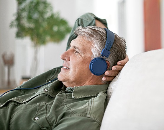 A man wearing headphones, relaxing.