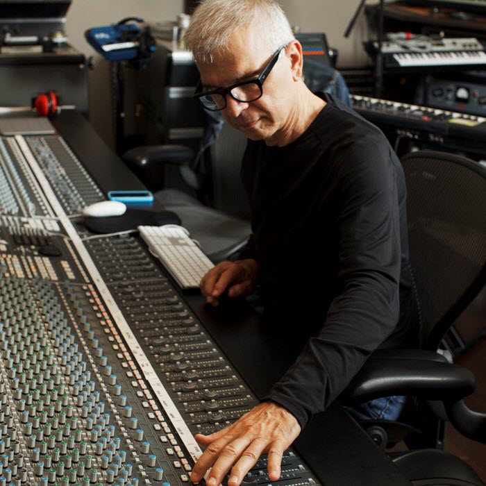 Man at sound recording studio's sound board.