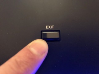 A finger presing "exit" button.