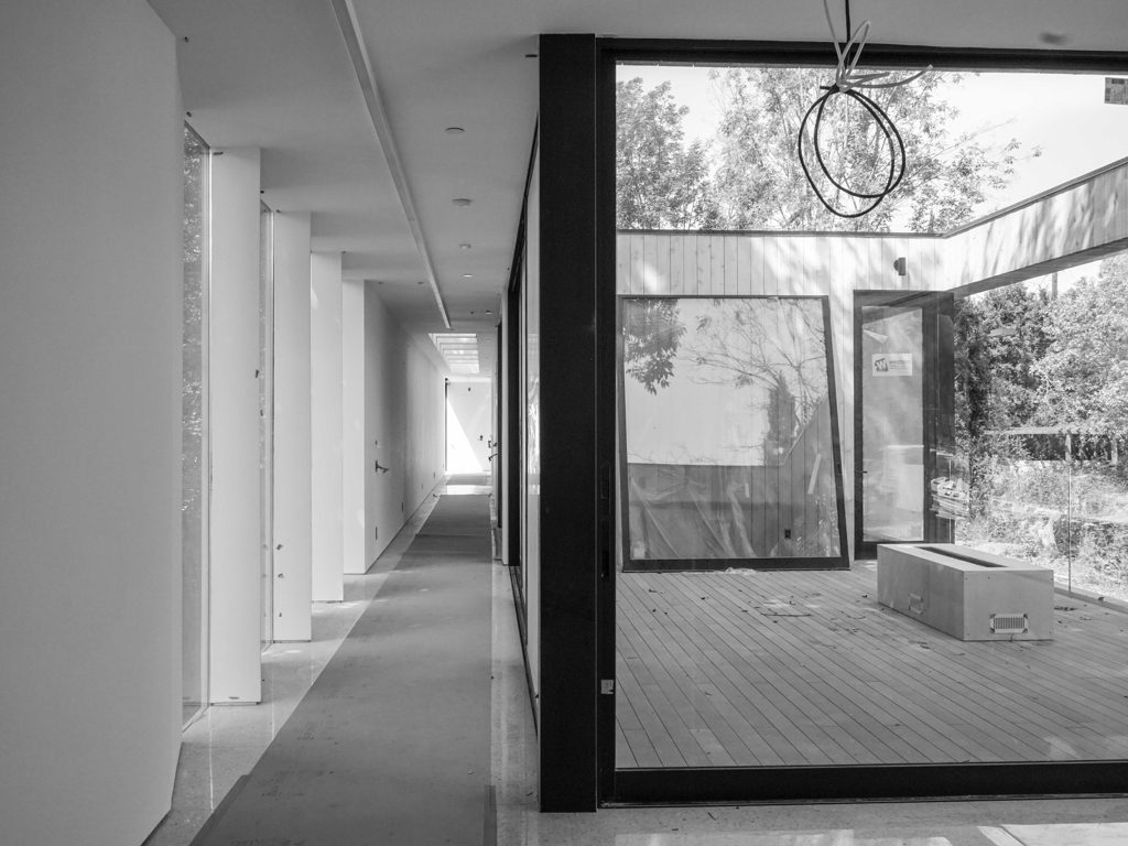 Hallway with windows and an outdoor patio adjacent.