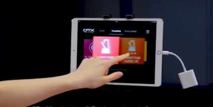 An image of a hand selecting an app on a tablet screen.