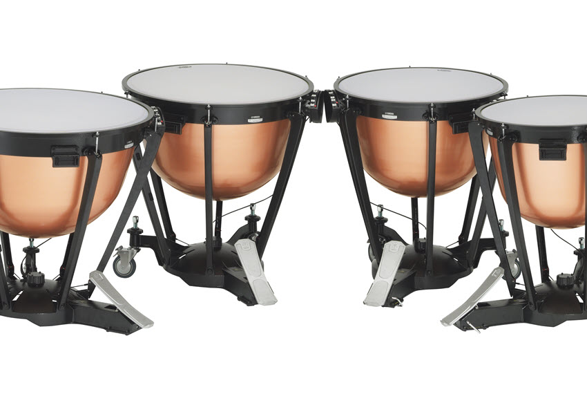 Four timpani drums in a curved row.