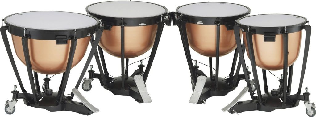 Set of 4 timpani drums in a curved row.