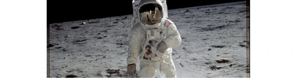 Person in space suit on surface of moon.