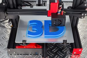 A 3-D printer in the process of printing out "3 D".