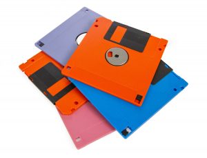 A pile of four 3.5 inch computer disks.