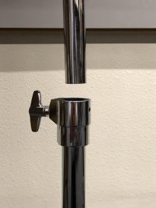 Shows the two tubes being connected where there is the one on bottom has a screw with a little handle for turning and tightening.