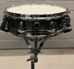 Closeup of snare drum on stand.