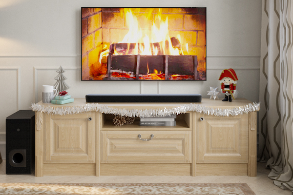 Holiday living room entertainment center with fireplace shown on television and sound bar.