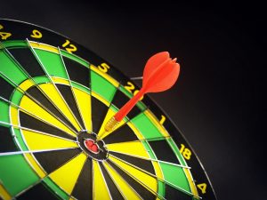 dart board with dart in the bullseye