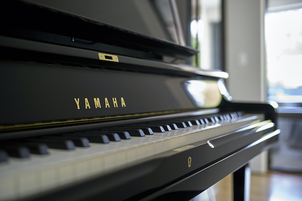 Soft-focus shot of Yamaha piano keys.