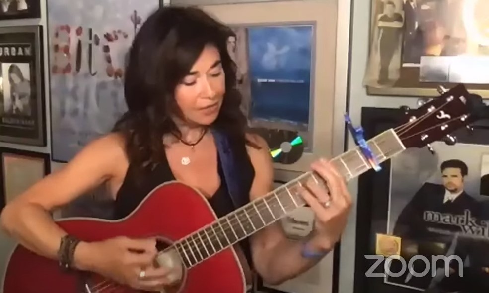 Shelly Peiken playing red FS-TA guitar during Zoom livestream.