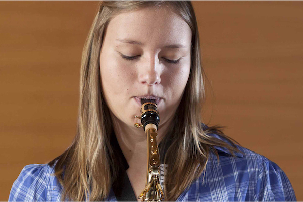 Young girl playing the saxophone.