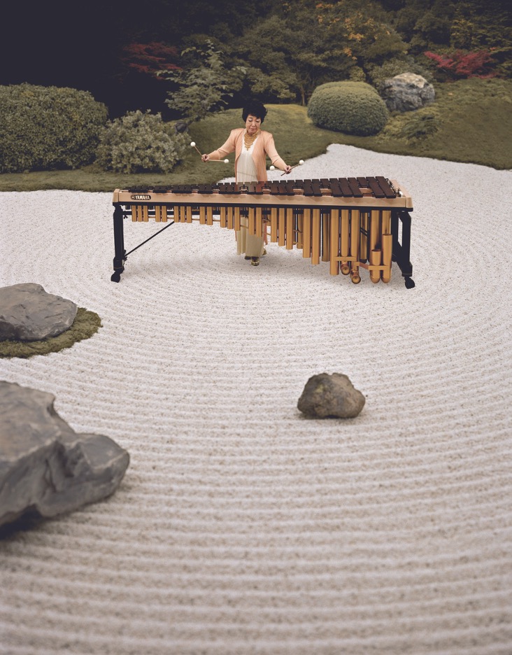 woman playing marimba in sand