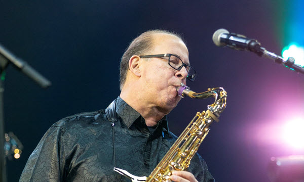 Man playing saxophone on stage.